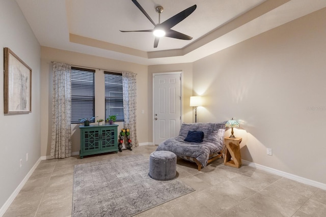 bedroom with ceiling fan and a tray ceiling