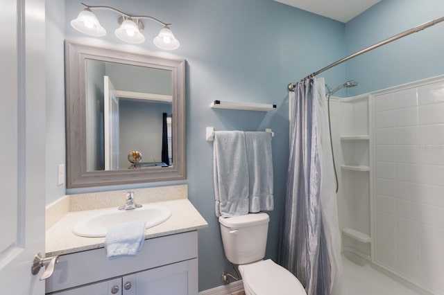 bathroom featuring toilet, vanity, and a shower with shower curtain