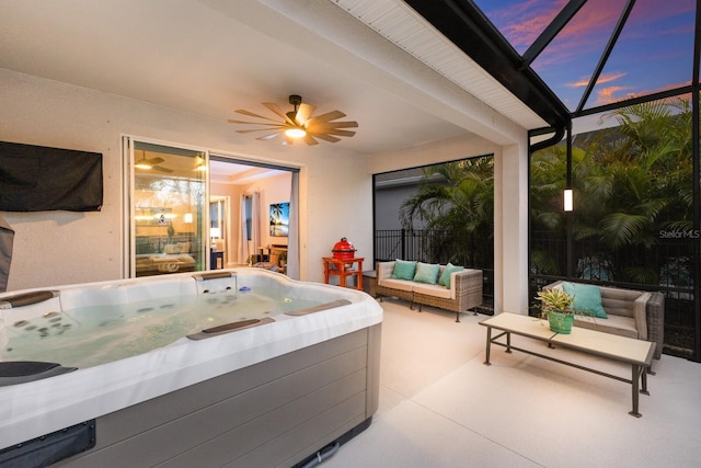 interior space featuring ceiling fan, a hot tub, outdoor lounge area, and glass enclosure