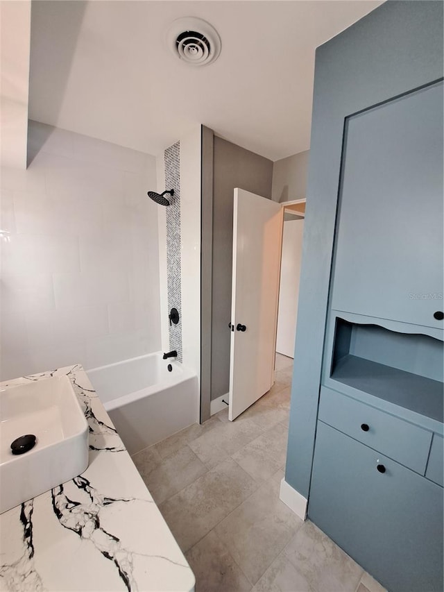 bathroom featuring bathing tub / shower combination and sink