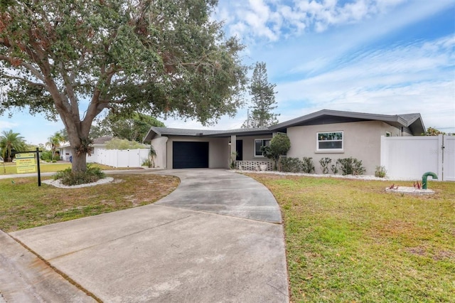 ranch-style home featuring a garage and a front lawn