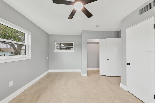 unfurnished bedroom featuring ceiling fan and a closet