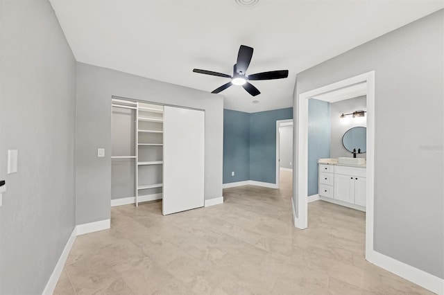 unfurnished bedroom with sink, ensuite bath, a closet, and ceiling fan