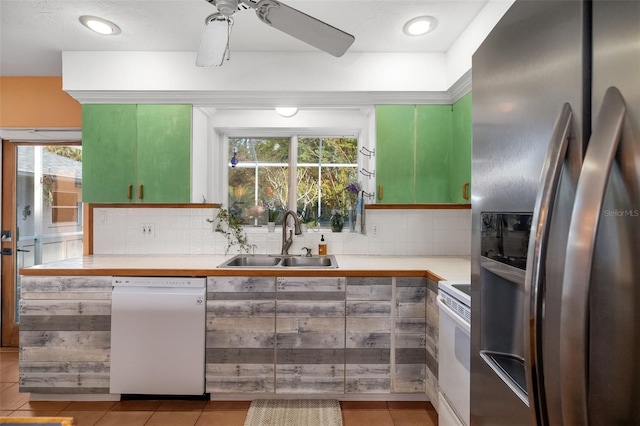 kitchen featuring light tile patterned floors, sink, decorative backsplash, and white appliances