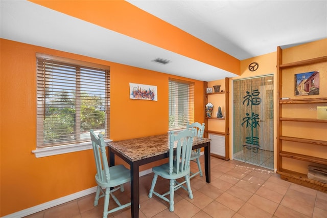 dining space featuring light tile patterned floors