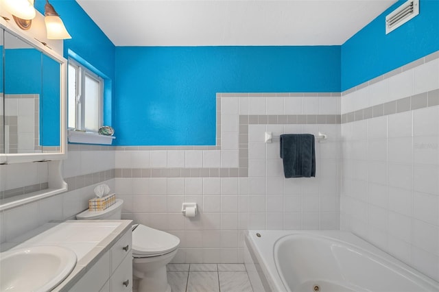 bathroom with toilet, a bathing tub, tile walls, and vanity