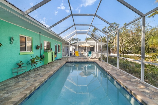 view of pool featuring a patio area and glass enclosure