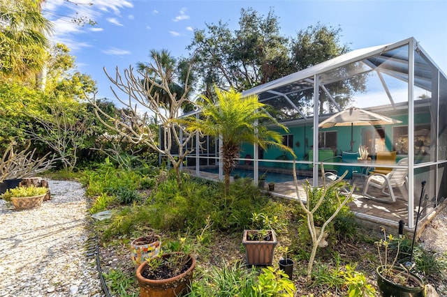 exterior space with glass enclosure and a patio