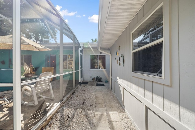 view of side of home with a lanai and a patio area