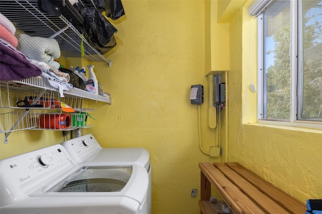 clothes washing area with washing machine and clothes dryer