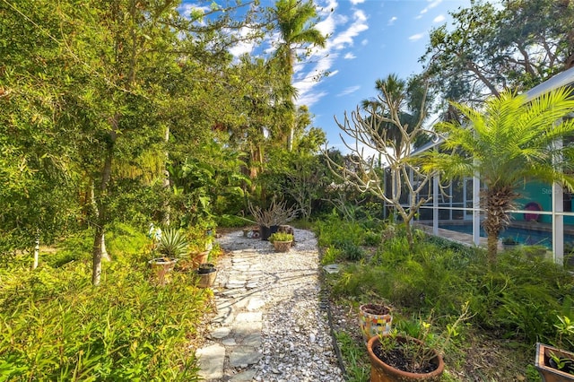 view of yard with a patio and glass enclosure