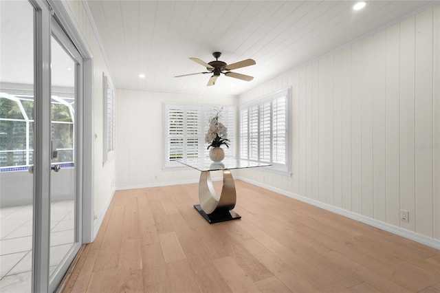 interior space featuring crown molding, ceiling fan, light hardwood / wood-style flooring, and a healthy amount of sunlight