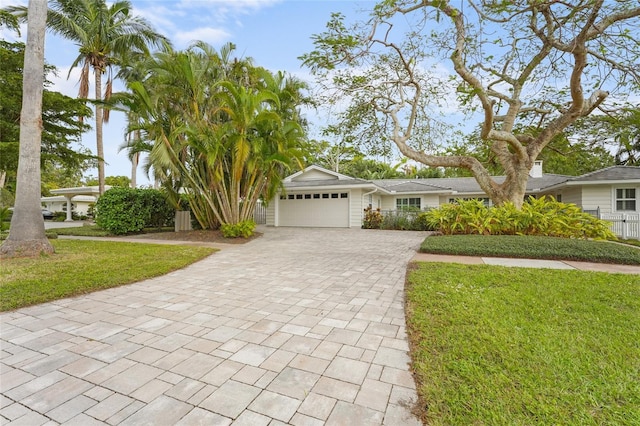 view of front facade featuring a garage and a front lawn