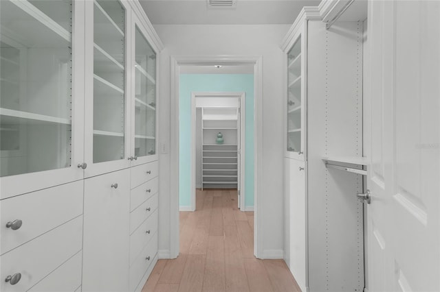 spacious closet with light hardwood / wood-style floors