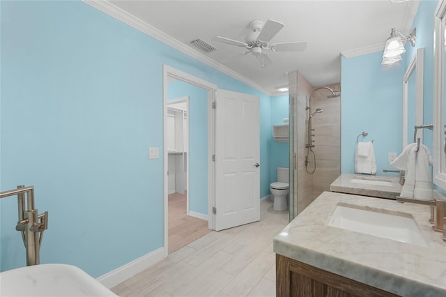 bathroom with ceiling fan, toilet, a tile shower, and crown molding