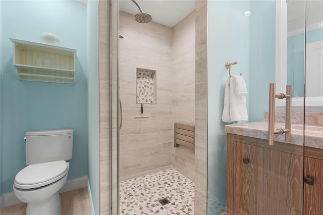 bathroom with toilet and a tile shower