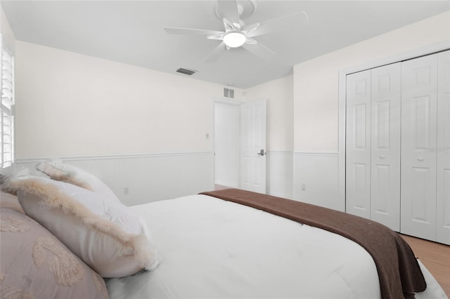 bedroom with wood-type flooring, a closet, and ceiling fan