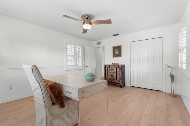 office space featuring light wood-type flooring and ceiling fan