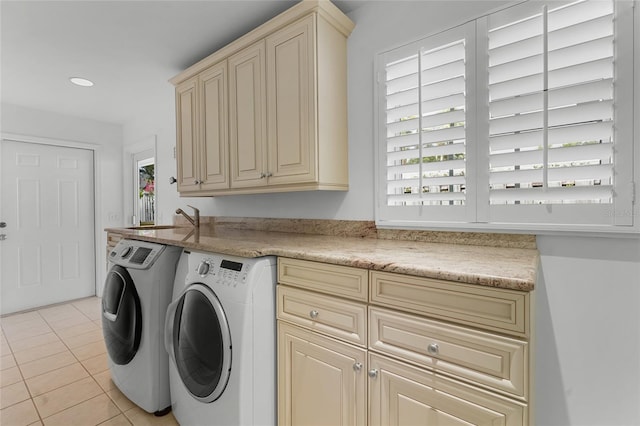 laundry area with separate washer and dryer, a healthy amount of sunlight, light tile patterned floors, and cabinets