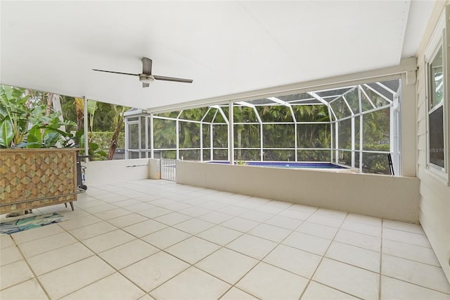 view of patio with glass enclosure and ceiling fan