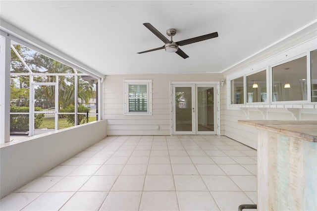 unfurnished sunroom with ceiling fan