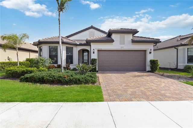 mediterranean / spanish-style home featuring a garage