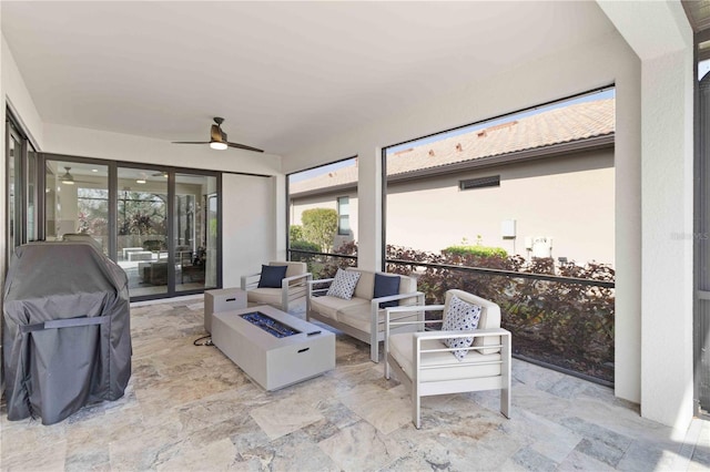 sunroom featuring a wealth of natural light and ceiling fan