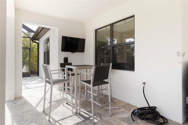 view of patio with glass enclosure