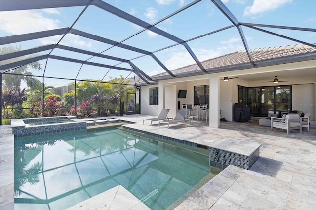 view of pool with an in ground hot tub, glass enclosure, ceiling fan, and a patio area