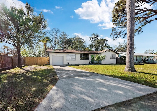 single story home with a garage and a front lawn