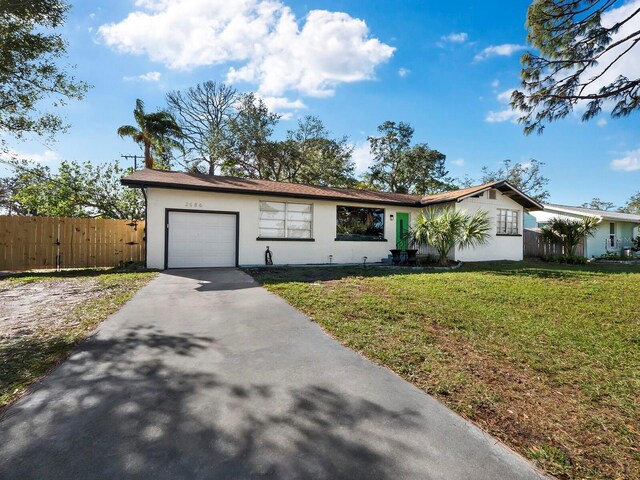 single story home with a garage and a front lawn