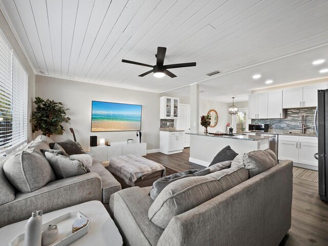 living room featuring wooden ceiling, sink, crown molding, dark hardwood / wood-style floors, and ceiling fan