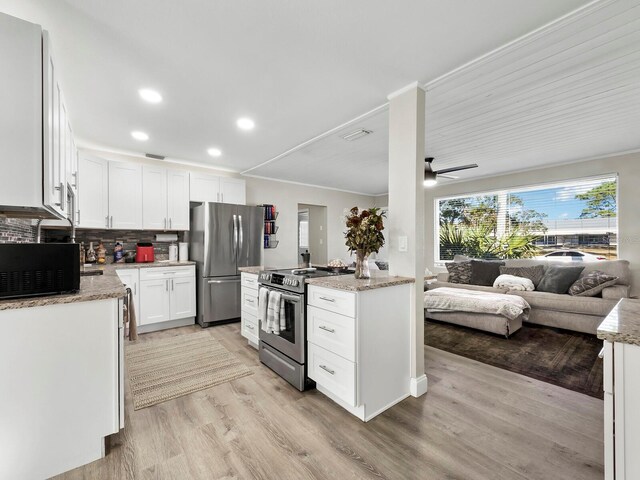 kitchen with ceiling fan, stainless steel appliances, tasteful backsplash, light hardwood / wood-style floors, and white cabinets