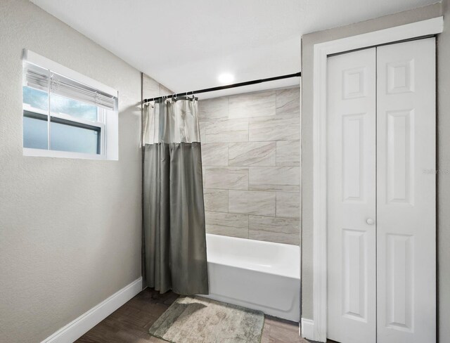 bathroom featuring shower / bathtub combination with curtain and wood-type flooring