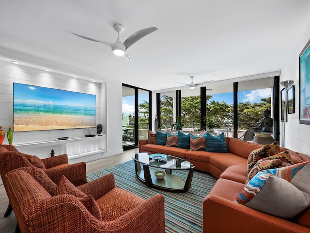 living room with ceiling fan and light hardwood / wood-style flooring