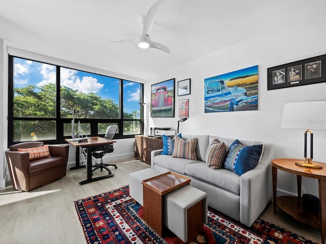 living room with light hardwood / wood-style floors and ceiling fan