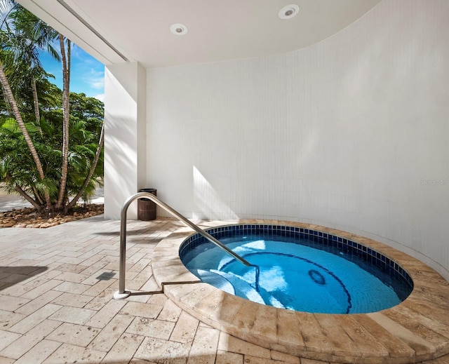 view of swimming pool with an in ground hot tub and a patio area