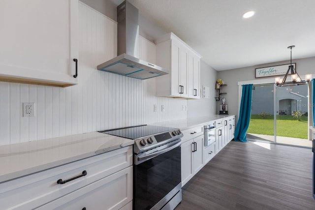 15404 Trinity Fall Way, Bradenton, FL 34212 - kitchen featuring stainless steel electric range oven, wall chimney exhaust hood, white cabinets, dark wood finished floors, and a chandelier