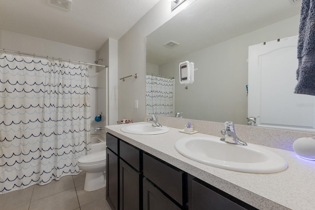 full bathroom featuring shower / bath combo, vanity, tile patterned flooring, toilet, and a textured ceiling