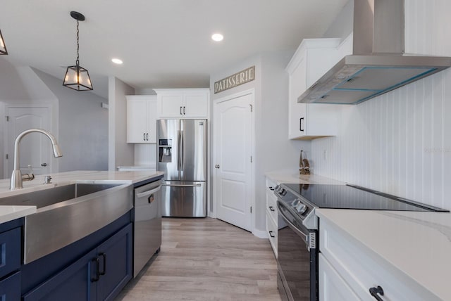 15404 Trinity Fall Way, Bradenton, FL 34212 - kitchen featuring stainless steel appliances, wall chimney range hood, blue cabinetry, a sink, and recessed lighting