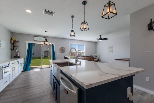 15404 Trinity Fall Way, Bradenton, FL 34212 - kitchen featuring dishwasher, a sink, wood finished floors, a kitchen island with sink, and pendant lighting