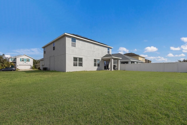 15404 Trinity Fall Way, Bradenton, FL 34212 - back of property with roof mounted solar panels, stucco siding, and central air condition unit