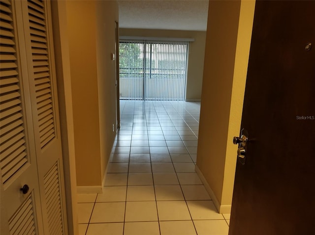 hall with light tile patterned floors