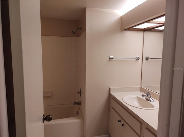 bathroom featuring vanity and tiled shower / bath