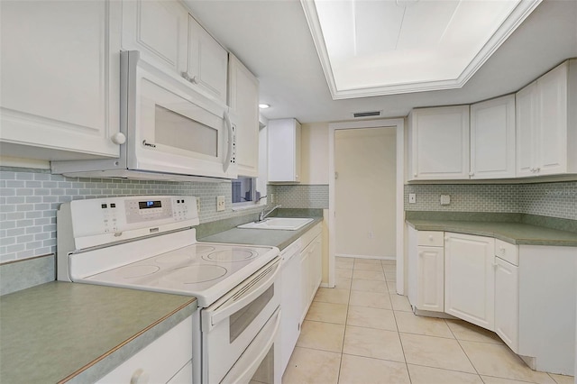 kitchen featuring backsplash, white appliances, sink, white cabinets, and light tile patterned flooring