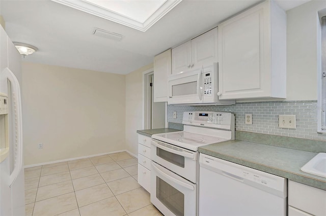 kitchen featuring white appliances, sink, light tile patterned floors, tasteful backsplash, and white cabinetry