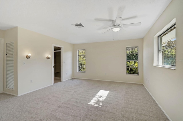 empty room with ceiling fan and light colored carpet