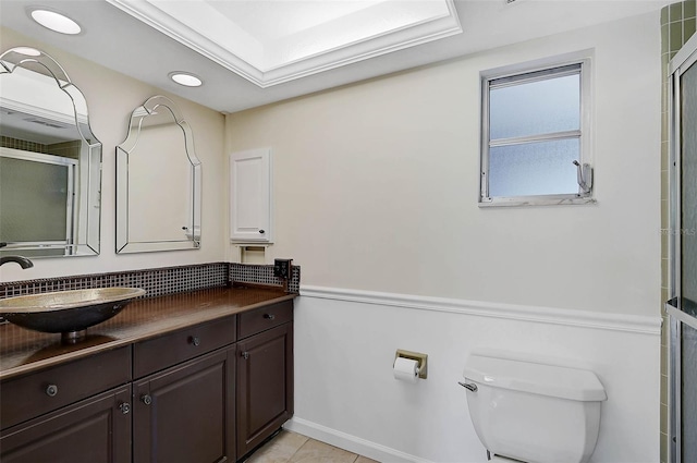 bathroom with vanity, crown molding, tile patterned flooring, toilet, and an enclosed shower