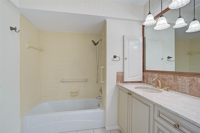 bathroom with tile patterned floors, decorative backsplash, vanity, and tiled shower / bath