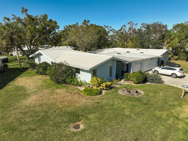 view of front of home featuring a garage and a front yard